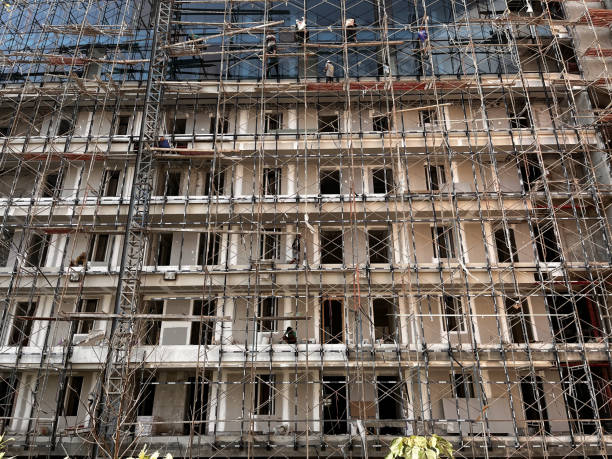 istock construction of buildings, apartments using scaffolding 1703577723