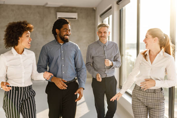 istock Happy business team having a conversation in the office. 1703578290