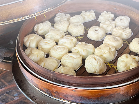 Bakpao, Baozi Steamed bun, pao, dim sum on In a bamboo steamer. a type of yeast-leavened filled bun in various Chinese cuisines.