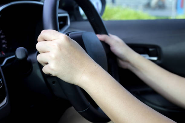 istock Hands holding steering wheel of car 1703585032