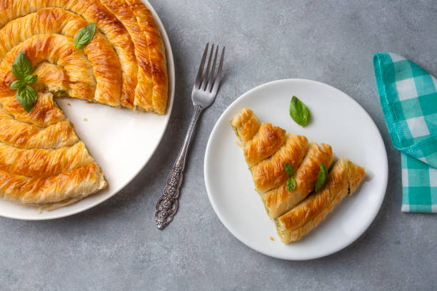 istock Turkish Tepsi Boregi, Round Borek, Tray pastry (Turkish name; rulo borek - ispanakli borek) 1703586151