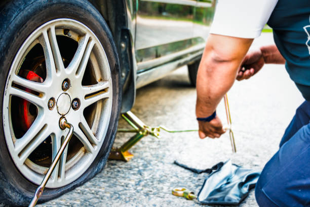 istock Changing the tire car on a road 1703597077
