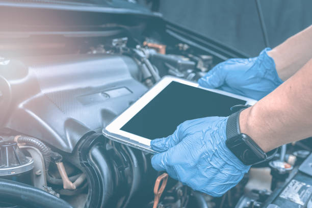 istock Auto mechanic working on car broken engine in mechanics service or garage.repair service Take authentic close-up photos 1703597622