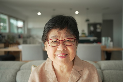 Healthy and confident pov portrait of Asian senior woman looking at camera