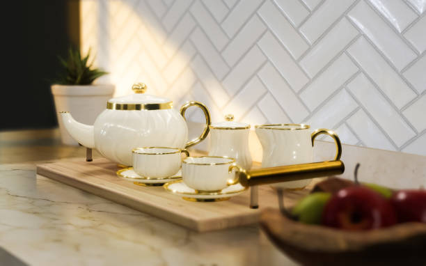 istock Tea set, a teapot, cup, milk jug and sugar bowl on kitchen countertop 1703614721