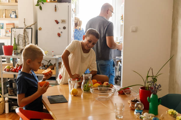istock Boys making citrus juices on the dining table 1703627864