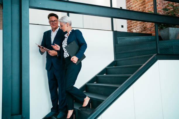 istock Business colleagues talking on stairs. 1703628445