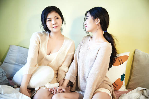 istock Asian best friends resting and relaxing on the sofa 1703631937