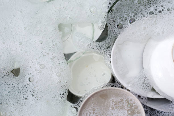 istock Dishes and bowls in water and bubbles of dishwashing liquid. Kitchen work 1703640243