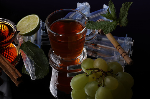 unfiltered, raw apple cider vinegar with mother  - a small glass bowl against rustic wood with a copy space