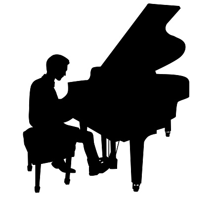 Young male pianist sitting and practicing at a baby grand piano