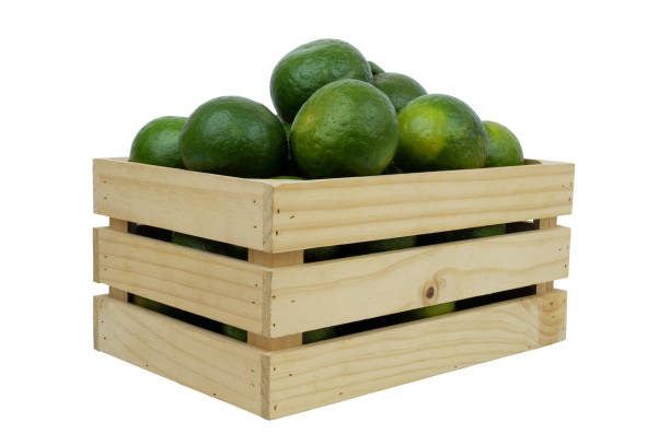istock Green oranges in wooden box isolated on white 1703662733