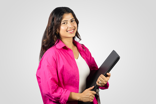 Young and Beautiful Asian Nepalese Student Abroad Study Giving gestures with notebook in hand