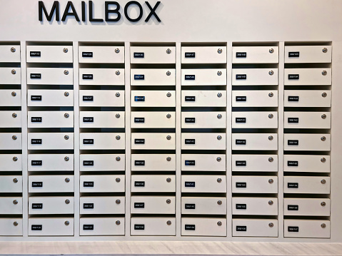 Mailbox or post office full of numbers In an apartment building on an abstract background.