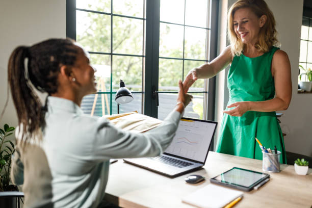 istock Two diverse businesswomen shaking hands upon meeting 1703711469