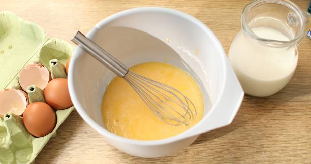 istock milk and beat with eggs and flour. Cooking butter for baking. 1703711479