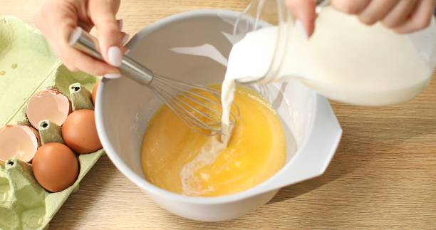 istock Add milk and beat with eggs and flour. Cooking butter for baking. 1703711486