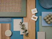 Creative flat lay composition in blue, gray and brown color palette with textile and paint samples, lamella panels and tiles. Architect and interior designer moodboard. Top view. Copy space.