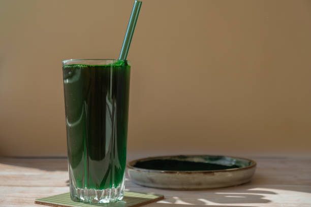 istock Natural organic green spirulina algae powder drink on neutral beige background. Chlorella seaweed vegan superfood cocktails smoothie supplement source and detox drinking. Innovative ingredient functional environmentally friendly food. Copy space 1703722983
