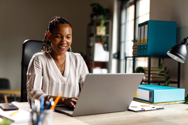 istock Charming businesswoman typing data on laptop at her desk 1703726288