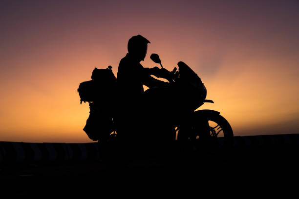 istock biker men and classic motorcycle at sunset 1703729682