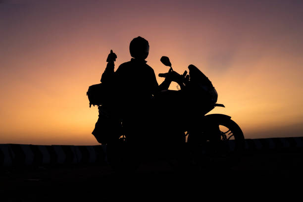 istock biker men and classic motorcycle at sunset 1703730188