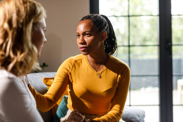 istock Two diverse girlfriends holding hands, having a sincere conversation 1703734002