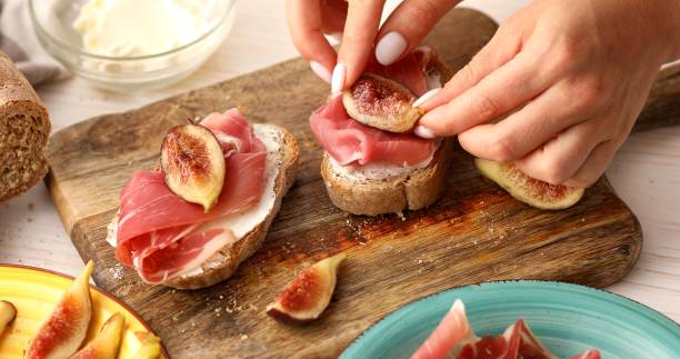 istock The process of making a sandwich with prosciutto and figs. 1703736341
