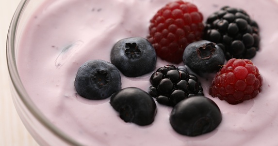 Yogurt with blueberries, blackberries and raspberries Close-up. Healthly food.