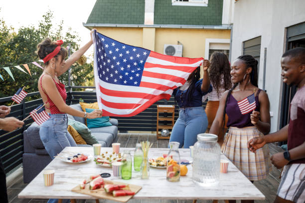 istock Waving a big American flag and dancing while celebrating Independence Day 1703754144