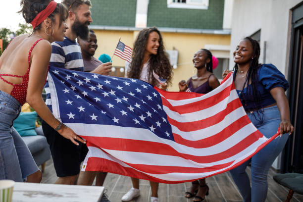 istock Waving a big American flag and dancing while celebrating Independence Day 1703754145