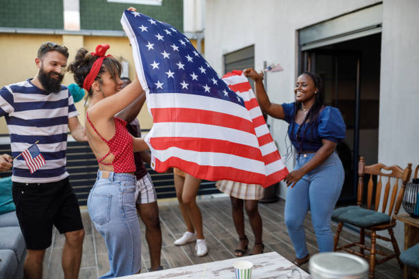 istock Waving a big American flag and dancing while celebrating Independence Day 1703754152