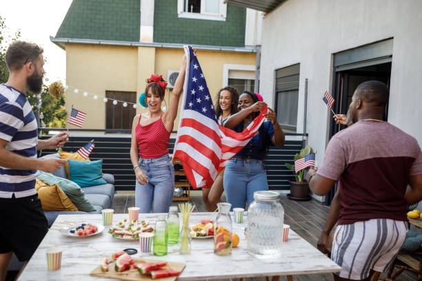 istock Waving a big American flag and dancing while celebrating Independence Day 1703754158