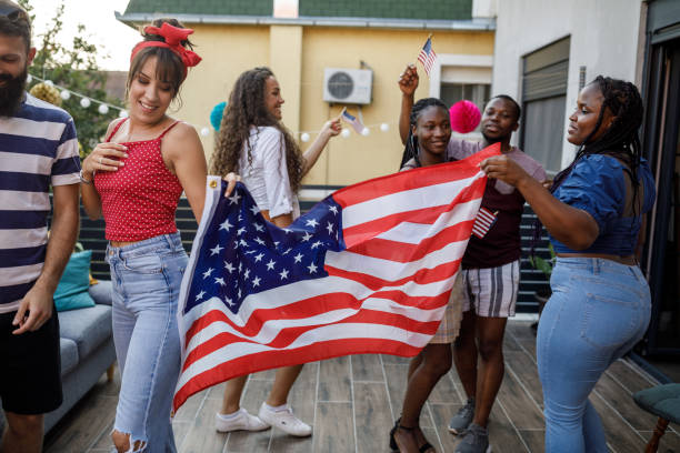 istock Waving a big American flag and dancing while celebrating Independence Day 1703754162