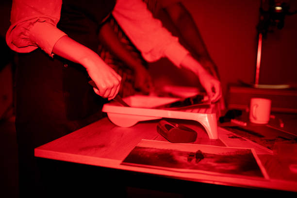 istock Photographers make photos in a darkroom 1703777588
