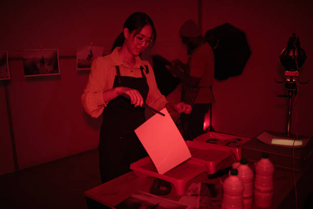 istock Photographers make photos in a darkroom 1703781858