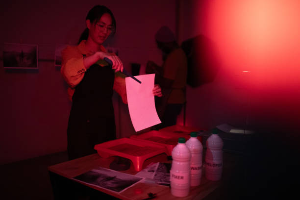 istock Photographers make photos in a darkroom 1703782402