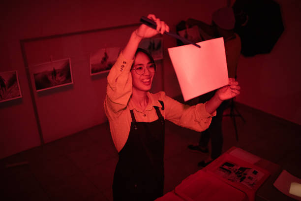 istock Girl developing photos in darkroom 1703782929