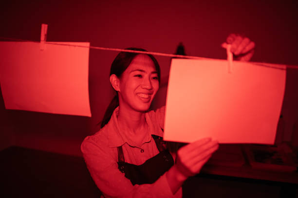 istock Girl developing photos in darkroom 1703788107
