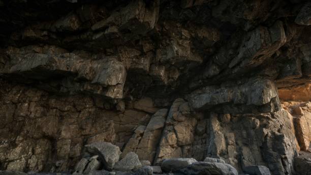 istock Sunlight falls on the textured wall of the cave 1703796496