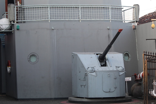 cannon armament on a warship with a dark gray color