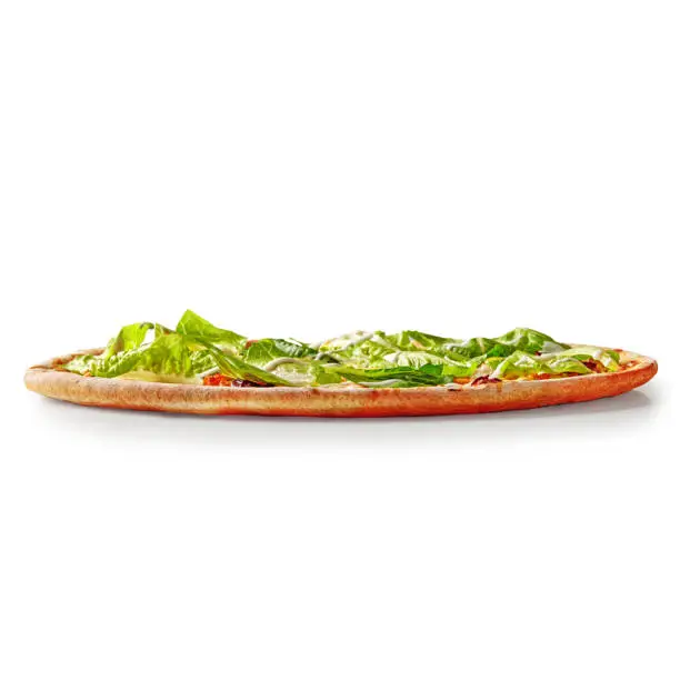Photo of Thin pizza with browned edge topped with lettuce and cream cheese sauce