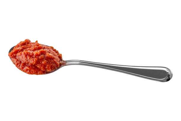 Spoon with tomato sauce isolated on white with clipping path included