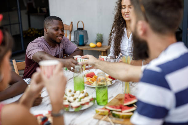 istock Friends enjoying refreshing drinks and snacks during a relaxing party on the balcony 1703827877