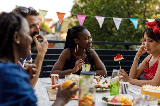 istock Friends snacking on delicious foods, chatting and bonding 1703828009