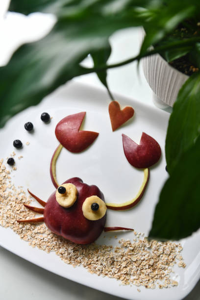 istock Crab Shaped Apple With Heart On Top Standing On Oats Depicted As Sand 1703841182