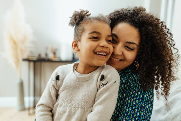 istock Mother cuddling with four year old daughter at home 1703842853