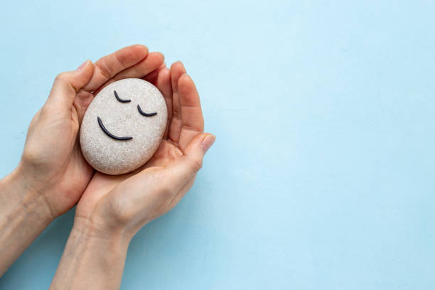 istock Marble stone face in female hands. Relaxation and meditation concept 1703844481