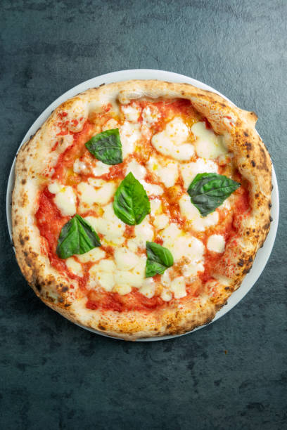 istock Neapolitan pizza margherita at the pizzeria table 1703845078