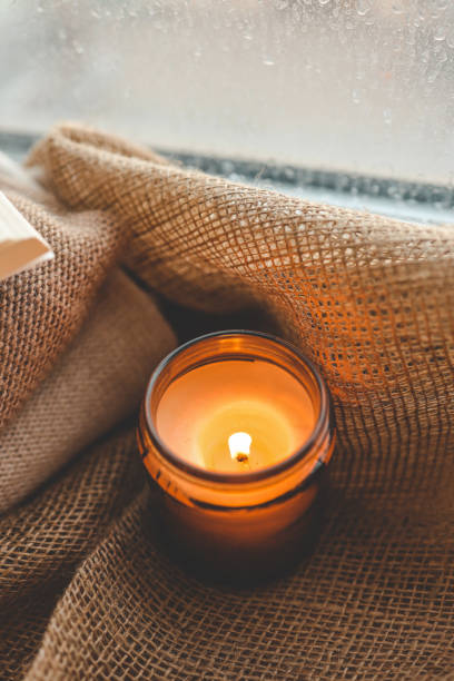 istock Burning candle close-up by the window 1703845140